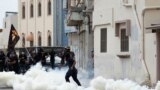An anti-government protester throws a stone at riot police amid teargas fired by the police during clashes in the village of Diraz, west of Manama, Bahrain. Protests following the death of 20-year-old Fadhel Abbas threatened to sour a new attempt to restart negotiations between Bahrain&#39;s government, led by the ruling al-Khalifa family, and opposition groups.