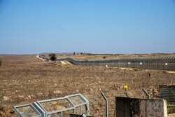 FILE - A security fence is pictured near the border area between Israel and Syria, in the Israeli-occupied Golan Heights, Nov. 18, 2020.