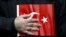 FILE - A supporter of Gulen movement holds a Turkey's national flag during a protest outside the Kanalturk and Bugun TV building in Istanbul, Turkey, Oct. 28, 2015. 