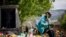 Kamloops Indian Residential School survivor Stanley Paul, 76, sits by a makeshift memorial at the former residential school to honour the 215 children whose remains were discovered buried near the facility, in Kamloops, Canada, June 4, 2021. 