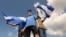 Young men wave national flags during a protest demanding the government release hundreds of protesters held in custody since 2018, in Managua, Nicaragua, March 16, 2019. 