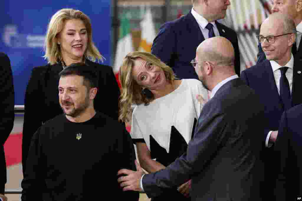 European Council President Charles Michel, 2nd right, talks to Italy&#39;s Prime Minister Giorgia Meloni, center, Ukraine&#39;s President Volodymyr Zelenskyy, bottom left, as they arrive for a group photo during an EU summit in Brussels, Belgium.