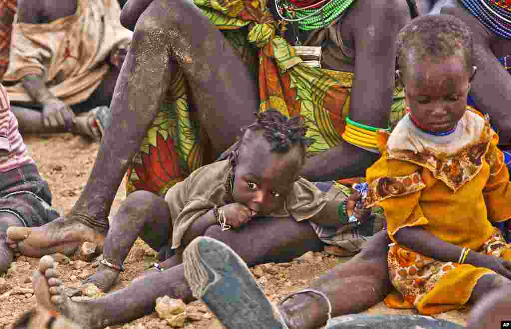 Turkana women and their children wait to receive relief food supplies near the Kakuma Refugee Camp, Turkana District, northwest of Kenya's capital Nairobi, August 8, 2011. (Reuters)