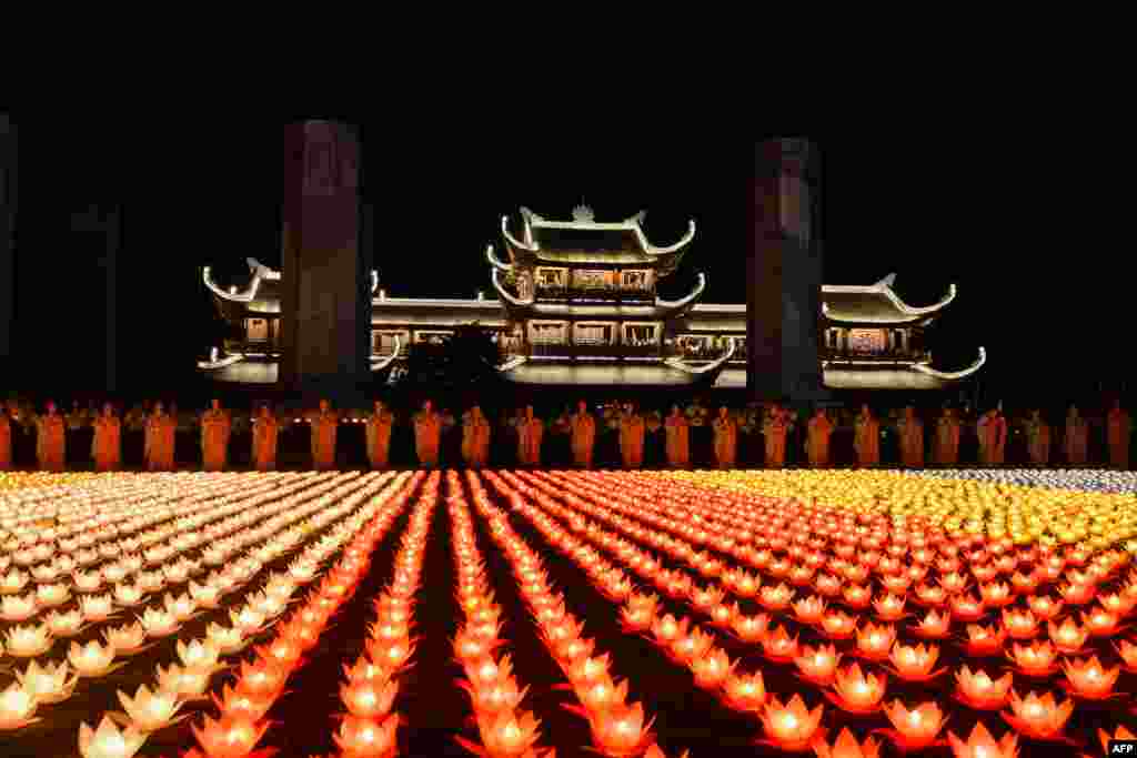 Buddhist nuns pray during a ceremony at the Tam Chuc pagoda in Ha Nam province, Vietnam, ahead of Vesak Day celebrations.