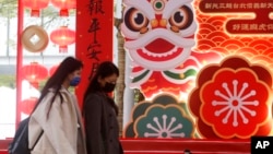 People walk past tiger decorations for the upcoming Chinese Lunar New Year, the Year of the Tiger according to the Chinese zodiac, in Taipei, Jan. 28, 2022.