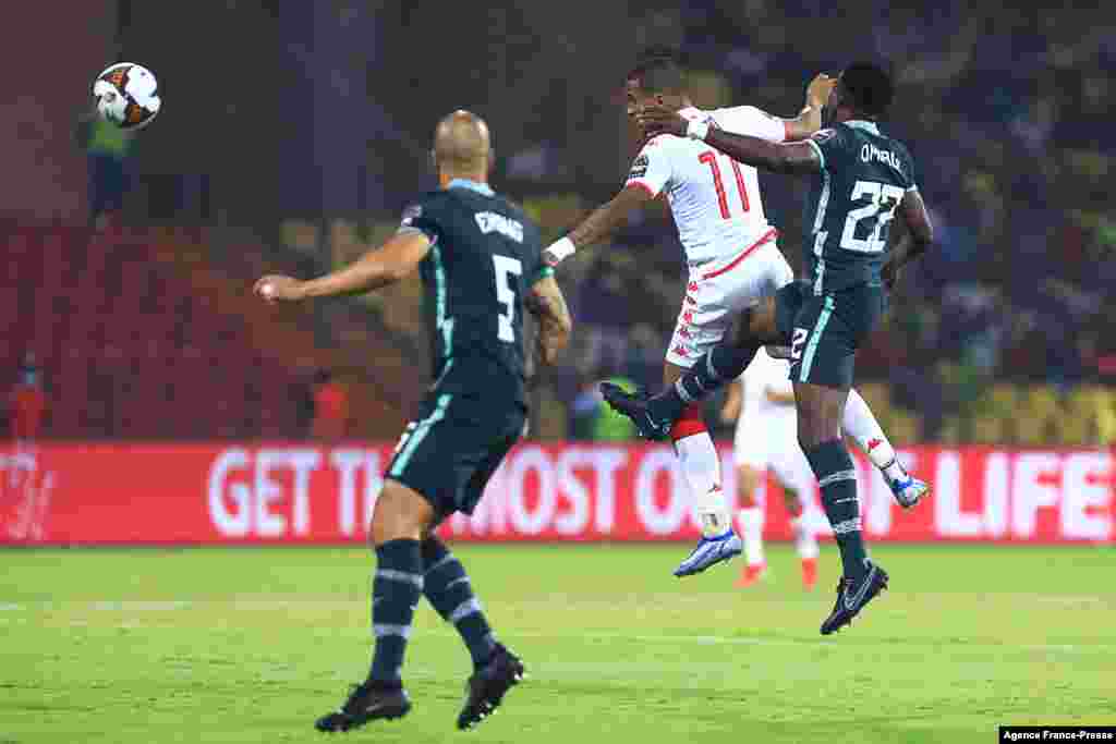 Tunisia&#39;s forward Seifeddine Jaziri (2R) and Nigeria&#39;s defender Kenneth Omeruo (R) jump for the ball during the round of 16 football match between Nigeria and Tunisia in Garoua, Cameroon on Jan. 23, 2022.