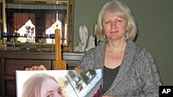 Lynne Russell holds a picture of her daughter, Siobhan, who was killed by a former boyfriend at the age of 19.
