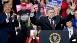 Republican Rick Saccone, right, acknowledges the crowd during a campaign rally with President Donald Trump, March 10, 2018, in Moon Township, Pa. Saccone is running against Democrat Conor Lamb in a special election Tuesday for the Pennsylvania 18th Congressional District vacated by Republican Tim Murphy.