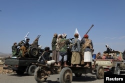 FILE - Houthi tribesmen parade to show defiance after U.S. and U.K. air strikes on Houthi positions near Sanaa, Yemen February 4,