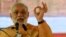 FILE - Indian Prime Minister and Bharatiya Janata Party leader Narendra Modi gestures as he speaks during a public rally ahead of the Maharashtra state election in Mumbai, October 2014.