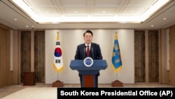 FILE - South Korean President Yoon Suk Yeol speaks at the South Korea Presidential Office in Seoul, South Korea, Dec. 12, 2024. A South Korean court has approved a detention warrant for Yoon, who faces insurrection charges. (South Korea Presidential Office via AP)