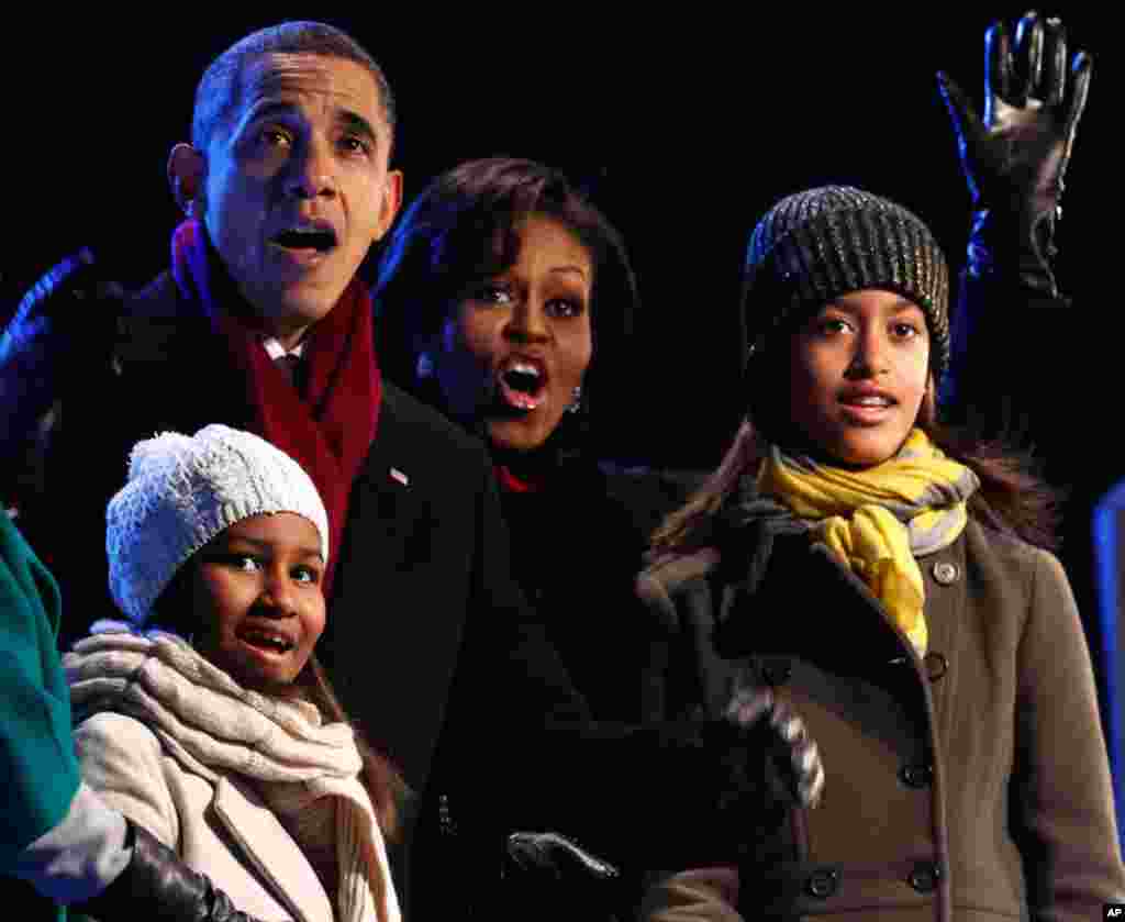 U.S. President Barack Obama and his family react as his daughter Sasha (L) pushes the button to light the National Christmas Tree during a ceremony on the Ellipse in Washington December 9. (Kevin Lamarque/Reuters)