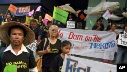 FILE - Thai villagers hold banners opposing the building of a dam on the Mekong river during a rally outside a construction company in Bangkok, Thailand Tuesday, April 24, 2012.