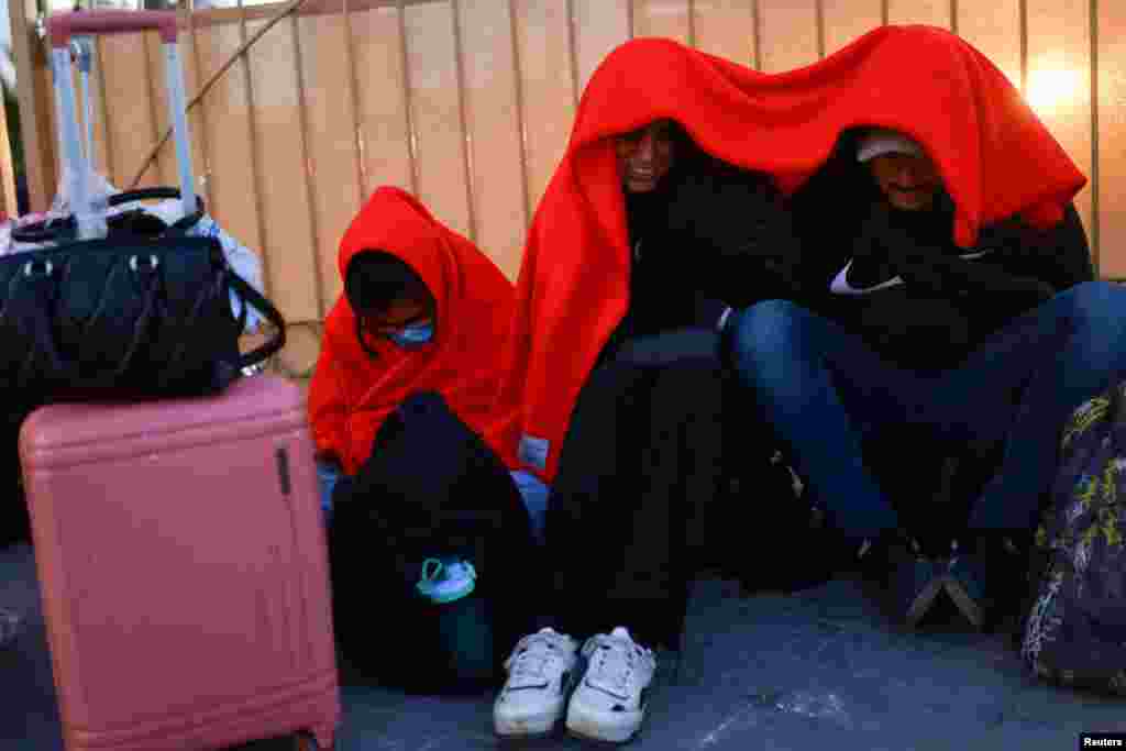 Migrants, seeking asylum in the United States and who previously requested an appointment on the U.S. Customs and Border Protection CBP One application, wait at the Paso del Norte International border bridge in Ciudad Juarez, Mexico.