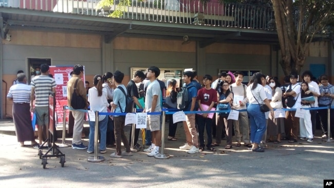 FILE - People wait in line to enter the Thai Embassy for visas in Yangon, Myanmar, on Feb. 20, 2024. Crowds of people have thronged to get passports and visas to neighboring Thailand since the government activated a law making 14 million young people subject to conscription.