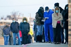 People wait in line to receive a COVID-19 vaccine at Ebenezer Baptist Church, in Oklahoma City, Jan. 26, 2021.