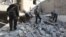 Free Syrian Army fighters and civilians search for bodies under rubble after an air strike by a fighter jet loyal to Syrian President Bashar al-Assad in Aleppo's al-Marja district December 31, 2012.