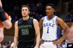 FILE - Dartmouth's Romeo Myrthil (20) stands next to Duke's Caleb Foster (1) during the second half of an NCAA college basketball game in Durham, N.C., Monday, Nov. 6, 2023. (AP Photo/Ben McKeown, File)
