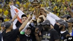 Los jugadores de los Golden State Warriors celebran su segundo título en los últimos tres años, al derrotar a Cleveland en la final de la NBA.