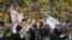 Golden State Warriors players, coaches and owners hold up the Larry O'Brien NBA Championship Trophy after Game 5 of basketball's NBA Finals between the Warriors and the Cleveland Cavaliers in Oakland, Calif., June 12, 2017.