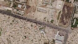 In this satellite photo taken by Planet Labs Inc., a Taliban checkpoint is seen blocking access just south of Kabul's international airport, Aug. 28, 2021. (Planet Labs Inc. via AP)