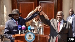 South Sudanese President Salva Kiir, left, South Sudan's opposition leader Riek Machar, right, and Mohamed Hamdan Daglo, Sudan's deputy head of the Transitional Military Council, hold hands after their peace talk in Juba, South Sudan, Dec. 17, 2019. 