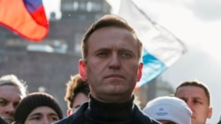 FILE - Russian opposition politician Alexei Navalny takes part in a rally to mark the 5th anniversary of opposition politician Boris Nemtsov's murder and to protest against proposed amendments to the country's constitution, in Moscow, Feb. 29, 2020.