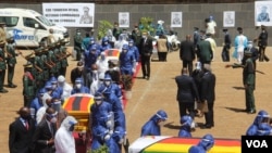Coffins of Minister of Foreign Affairs Sibusiso Moyo, Transport Minister Joel Biggie Matiza and former head of prisons Paradzai Zimond, in Harare, Jan. 27, 2021. (Columbus Mavhunga/VOA)