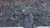 A pedestrian walks through a snow storm, in south Philadelphia, Pennsylvania, USA. The National Weather Service said the storm could bring 8 to 12 inches of snow to Philadelphia and New York City, and more than a foot in Boston.