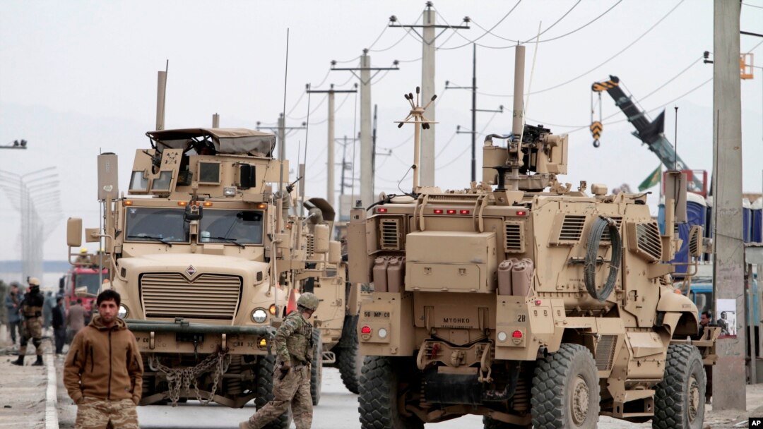 Afghan police and U.S. forces respond to a suicide car bomb attack on the Jalalabad-Kabul road in Kabul, Dec. 27, 2013. 