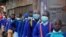 Schoolchildren queue to have their temperature checked before entering the Olympic Primary School during the reopening of schools, after the government closed learning institutions due COVID-19 outbreak, in Kibera slums of Nairobi, Jan. 4, 2021.