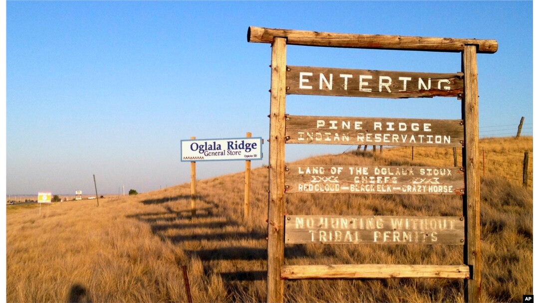 FILE - A sign hangs outside the entrance to Pine Ridge Indian Reservation in South Dakota, home to the Oglala Sioux Tribe, Sept. 9, 2012. Tribal leaders in South Dakota have denounced Governor Kristi Noem’s suggestion that drug cartels operate on reservation land.