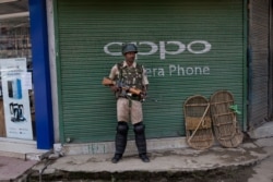 An Indian paramilitary soldier stands guard in Srinagar, Kashmir, Aug. 2, 2019. An Indian soldier was killed during a gunbattle with rebels in Kashmir Aug. 2.