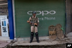 An Indian paramilitary soldier stands guard in Srinagar, Kashmir, Aug. 2, 2019. An Indian soldier was killed during a gunbattle with rebels in Kashmir Aug. 2.