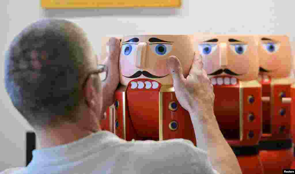 Toy maker Reiner Zimmermann assembles nutcrackers at the workshop of wood art manufacturer Seiffener Volkskunst in Seiffen, Germany.