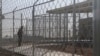 FILE - A Border Patrol agent wait to show reporters an immigration holding facility, Feb. 25, 2020, in El Paso, Texas.