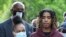 Taniyah Pilgrim listens to Messiah Young as he speaks during a news conference on the campus of Morehouse College, June 1, 2020, in Atlanta.