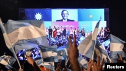 Supporters of Alberto Fernandez and his running mate and former President Cristina Fernandez de Kirchner, celebrate after Alberto Fernandez wins the general election, in Buenos Aires, Argentina, Oct. 27, 2019. 