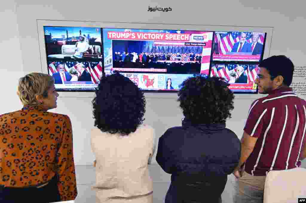 Kuwaiti journalists watch the news on the U.S. election results on a big TV screen at an office in Kuwait City on Nov. 6, 2024. 