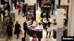 FILE - People shop in the Selfridges department store on Oxford street, in London, Britain, Apr. 2, 2021. 