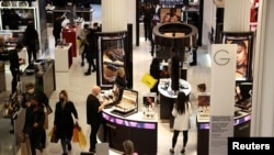 FILE - People shop in the Selfridges department store on Oxford street, in London, Britain, Apr. 2, 2021. 