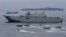 FILE - the Royal Australian Navy HMAS Adelaide cruises alongside landing crafts with Philippine Marines and Australian troops as they conduct a joint Humanitarian Aid and Disaster Relief (HADR) exercise off Subic Bay in northwestern Philippines.