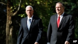 Vice President Mike Pence, left, and Secretary of State Mike Pompeo, walk to a car to drive to a meeting with Turkish President Recep Tayyip Erdogan, in Ankara, Turkey, Thursday, Oct. 17, 2019. (AP Photo/Jacquelyn Martin)