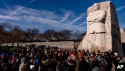 FILE - People attend a wreath-laying ceremony at the Martin Luther King Jr. Memorial marking MLK Day in Washington, Jan. 16, 2023.