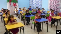 FILE - Schoolchildren attend a class Tuesday, Sept.19, 2023 in the Ben Omar district of Algiers. More tan 11 millions student are back to school.