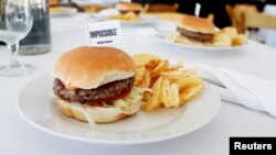 The completed plant-based hamburger is displayed during a media tour of Impossible Foods labs and processing..