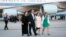Mark and Jackie Barden, parents of seven-year-old Daniel (L), walk with Nelba Marquez-Greene, mother of six-year-old Ana (C), and an unidentified woman from Air Force One after landing with President Barack Obama and other families who lost relatives, (File photo).