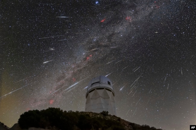 FILE - This Dec. 14, 2023 image made available by NOIRLab shows meteors from the Geminid meteor shower above the Nicholas U. Mayall Telescope at Kitt Peak National Observatory, a Program of NSF's NOIRLab, located about 90 kilometers southwest of Tucson. (NSF's NOIRLab via AP)