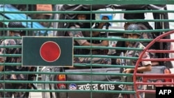 Bangladeshi border guard personnel stand guard at the India-Bangladesh border of Petrapole, about 100 kilometers (62 miles) northeast of Kolkata, on Aug. 6, 2024.