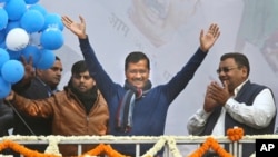 FILE - Delhi Chief Minister Arvind Kejriwal, center, waves at Aam Aadmi Party, or Common Man's Party, headquarters as they celebrate the party's victory in New Delhi, Feb. 11, 2020.